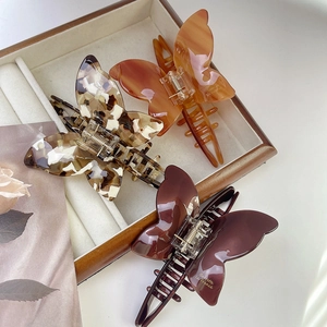 Three elegant acetate butterfly hair claws in amber and tortoiseshell for women