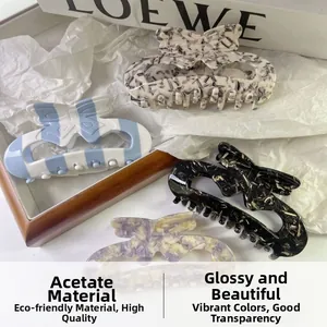 Detailed macro view of four acetate bow hair claws with various colorful patterns and textures