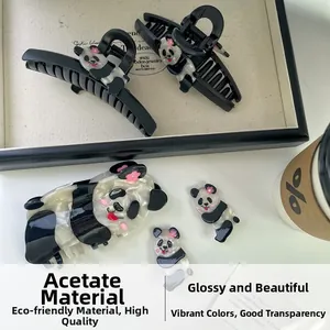 Close-up of premium panda acetate hair claw showing polished texture and floral details