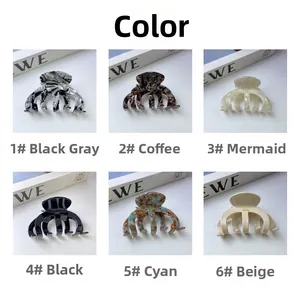 Vue détaillée de pinces à cheveux en acétate en six coloris avec motifs marbrés