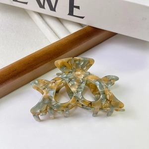 Close-up of amber and grey marble texture on large acetate hair claw clip accessory
