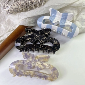 Elegant hollow butterfly acetate hair claws in various marbled and artistic patterns