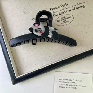 Detailed macro view of cute panda claw clip made of premium acetate and black glossy resin