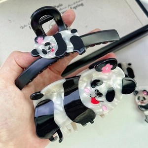 Detailed close-up of cute panda hair claws showing premium acetate texture and pearl finish