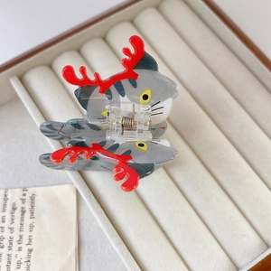 Detail of Christmas cat hair claw clip made of acetate with red reindeer antlers