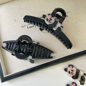 Cute cartoon panda acetate hair claw clip with black design and pink flower detail