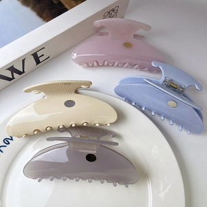 Chic vintage acetate scallop hair claws in four pastel colors with gold metal emblem