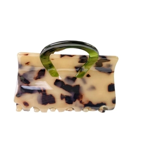 Chic rectangular acetate hair claw clip with cream tortoiseshell pattern and green handle