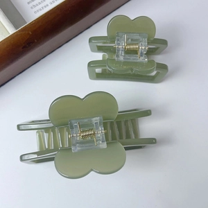 Detail of avocado green heart square hair claws in two sizes with matte finish
