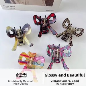 Detailed top view of five acetic acid butterfly hair claws in various vibrant patterns
