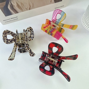 Three-piece set of acetate butterfly hair claws in leopard, striped, and plaid patterns