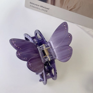 Détail de la pince à cheveux papillon violette en acétate avec strass et ressort doré