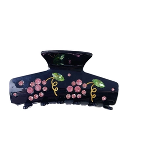 Elegant black hair claw with pink and green crystal grapes and golden spiral accents