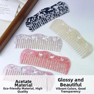 Detail of five hollow heart acetate hair combs in varied marble colors and wide tooth design