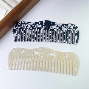 Fashionable heart cutout acetate wide-tooth combs in marble and pearl white finishes