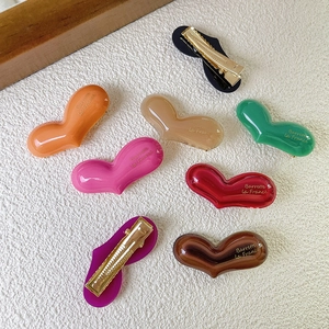 Colorful acetate heart hair clips with golden duckbill clips in various vibrant colors