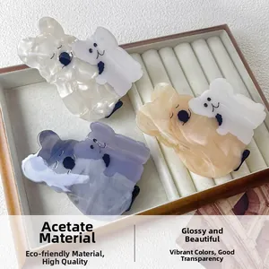 Detail of cute acetate koala hair claws showing glossy texture and marble patterns