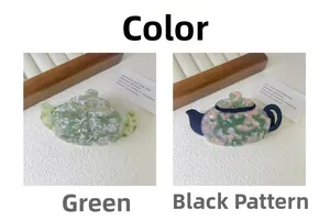Detailed view of teapot-shaped acetate hair clips in green and floral patterns