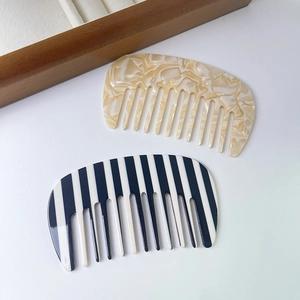 Handmade acetate wide-tooth U-shaped hair combs in marble and striped patterns