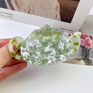 French retro acetate hair claw clip in teapot shape with green floral marble pattern