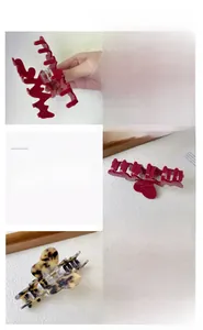 Dettaglio di grandi mollette per capelli in acetato rosso scuro e tartarugate
