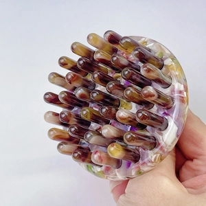 Manual head massage brush with floral acetate handle and rounded brown bristles
