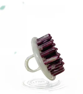 Close-up of marble pattern acetate massage comb with ergonomic handle and round teeth