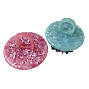 Pink and blue marble texture scalp massage brush with ergonomic ring handle and teeth