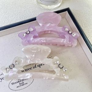 Lot de deux pinces à cheveux en acétate avec nœuds et strass en violet et blanc crème