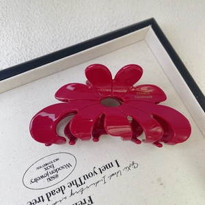 Detail of red flower acetate hair claw clip with gold France Handmade lettering