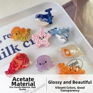 Detail of diverse marine ocean animal acetate hair claw clips displayed on a white tray