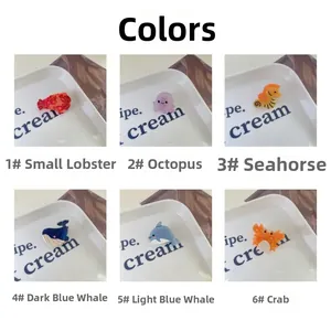 Detailed view of colorful sea creature acetate clips including whale and crab shapes