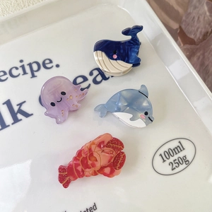 Whale and seahorse acetate hair clips set in elegant marble patterns for women