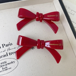 Set of high-gloss red acetate bow hair clips with golden Handmade LR lettering