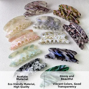 Macro detail of various acetate hair claws with elegant marble and tortoiseshell patterns