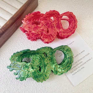Elegant acetate dragon hair claw clips in red and green with gold totem patterns