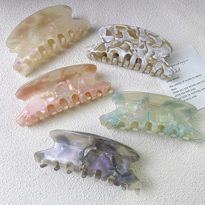 Elegant large acetate hair claws with marble texture in various chic pastel colors