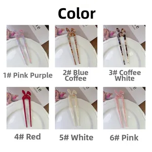 Close-up of rabbit ear acetate hair sticks in six different marble and solid colors