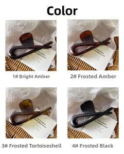Detailed grid view of minimalist large hair claws in amber and matte black finishes