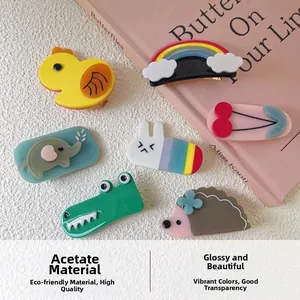Flat lay of colorful acetate hair clips with cute animal shapes like ducks and rabbits