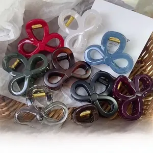 Detailed view of colorful PC bow-shaped hair claws in multiple matte and glossy finishes