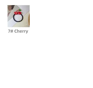 Detail view of high elasticity hair tie featuring red cherry resin charms with green leaves