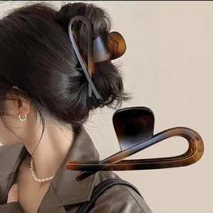 Matte tortoiseshell hair claw clip for women with large intersecting ring design for thick hair
