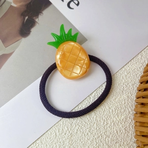 Detailed close-up of a high-elastic pineapple hair tie with a bright yellow resin fruit charm