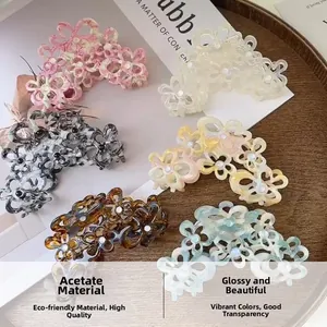 Detail of multi-colored acetate flower hair claws with elegant pearl centers