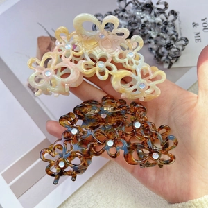 Elegant hollow floral acetate hair claw clip with rhinestones in iridescent and tortoise colors