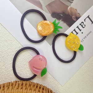 Three-piece fruit elastic hair ties featuring resin pineapple lemon and peach charms