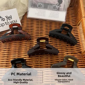 Detailed collection of five matte hair claws in retro colors on a woven tray