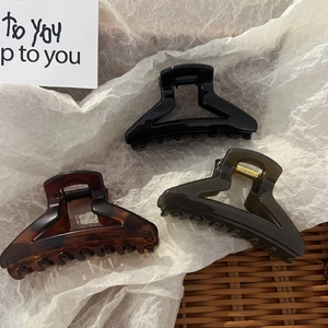 Three-piece hair claw set in black, amber leopard, and olive green with gold springs