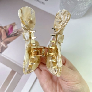 Elegant butterfly acetate hair claw clip with cream and brown marble texture and gold spring